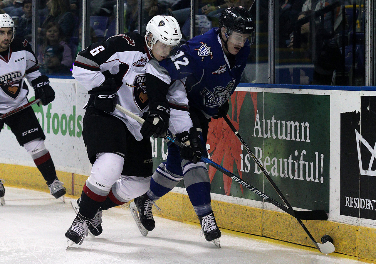 Vancouver Giants defenceman Dylan Plouffe battles for a puck along the wall