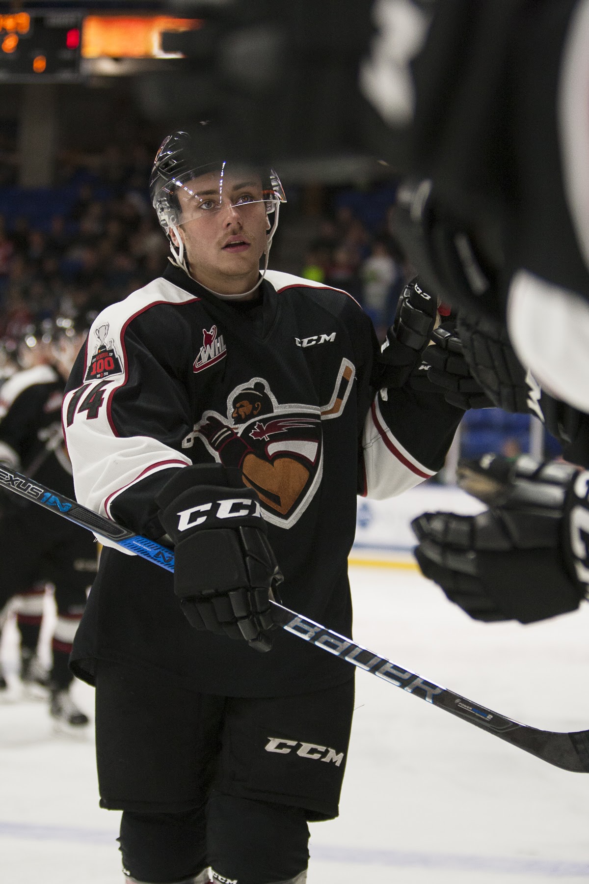 Vancouver Giants forward James Malm celebrates his hat-trick goal with his teammates.