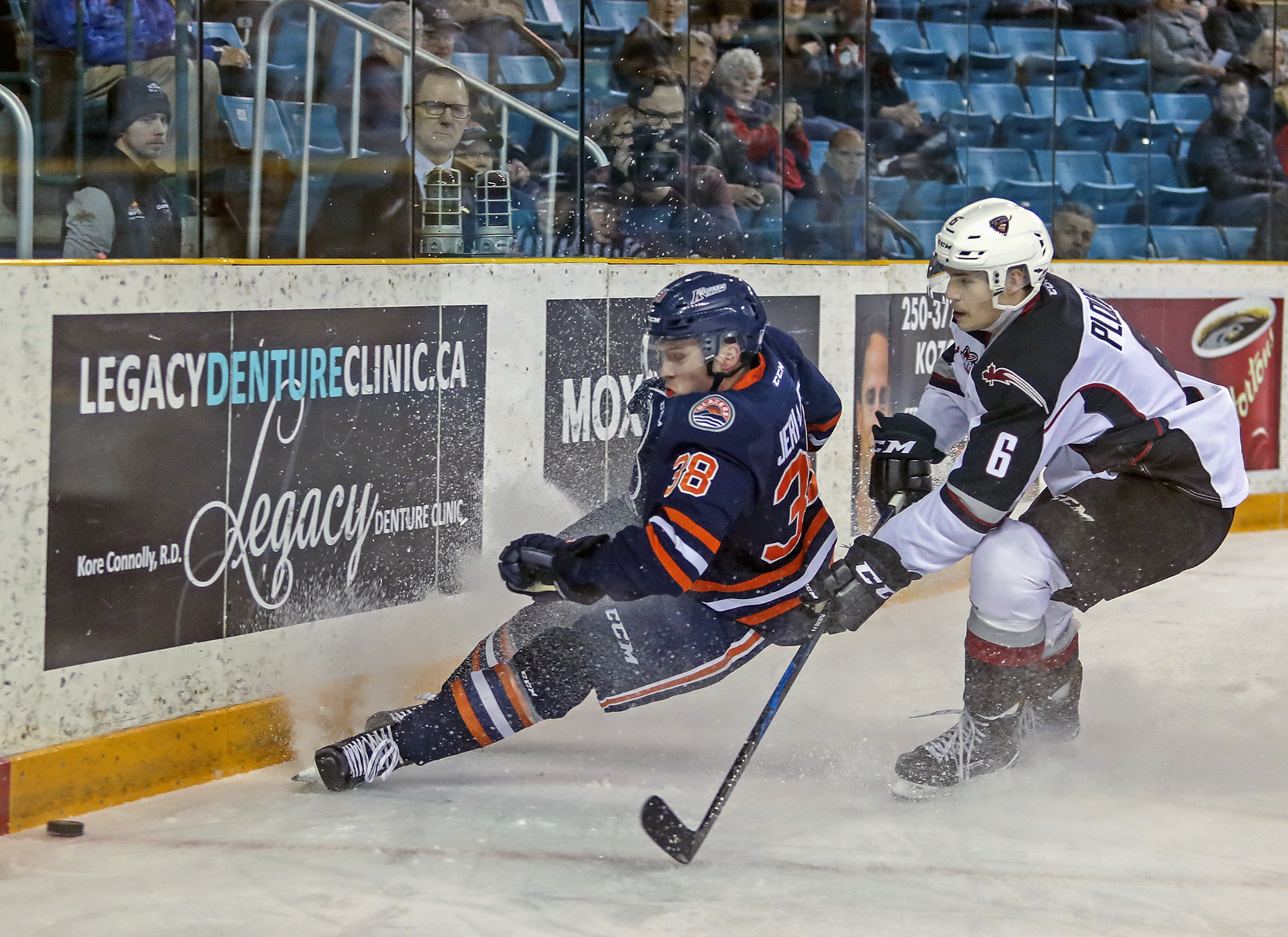 Dylan Plouffe of the Giants and Kelti Jeri-Leon do battle along the boards Friday in Kamloops.