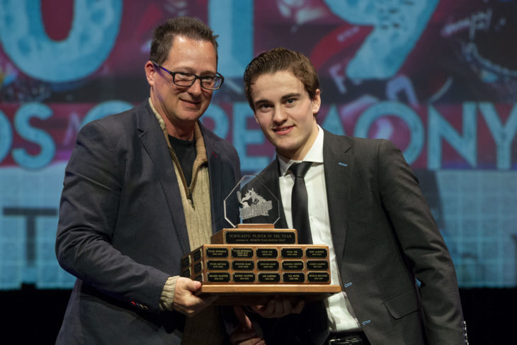 KELOWNA, BC - MARCH 17: Darren Wishlow presents Kyle Crosbie #25 of the Kelowna Rockets with the Scholastic Player of the Year award at the annual Kelowna Rockets awards ceremony at Kelowna Community Theatre on March 17, 2019 in Kelowna, Canada. (Photo by Marissa Baecker/Shoot the Breeze)