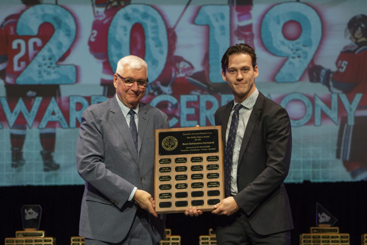 KELOWNA, BC - MARCH 17: President and GM, Bruce Hamilton presents the Best Defensive Forward award to Conner Bruggen-Cate #20 of the Kelowna Rockets at the annual Kelowna Rockets awards ceremony at Kelowna Community Theatre on March 17, 2019 in Kelowna, Canada. (Photo by Marissa Baecker/Shoot the Breeze)