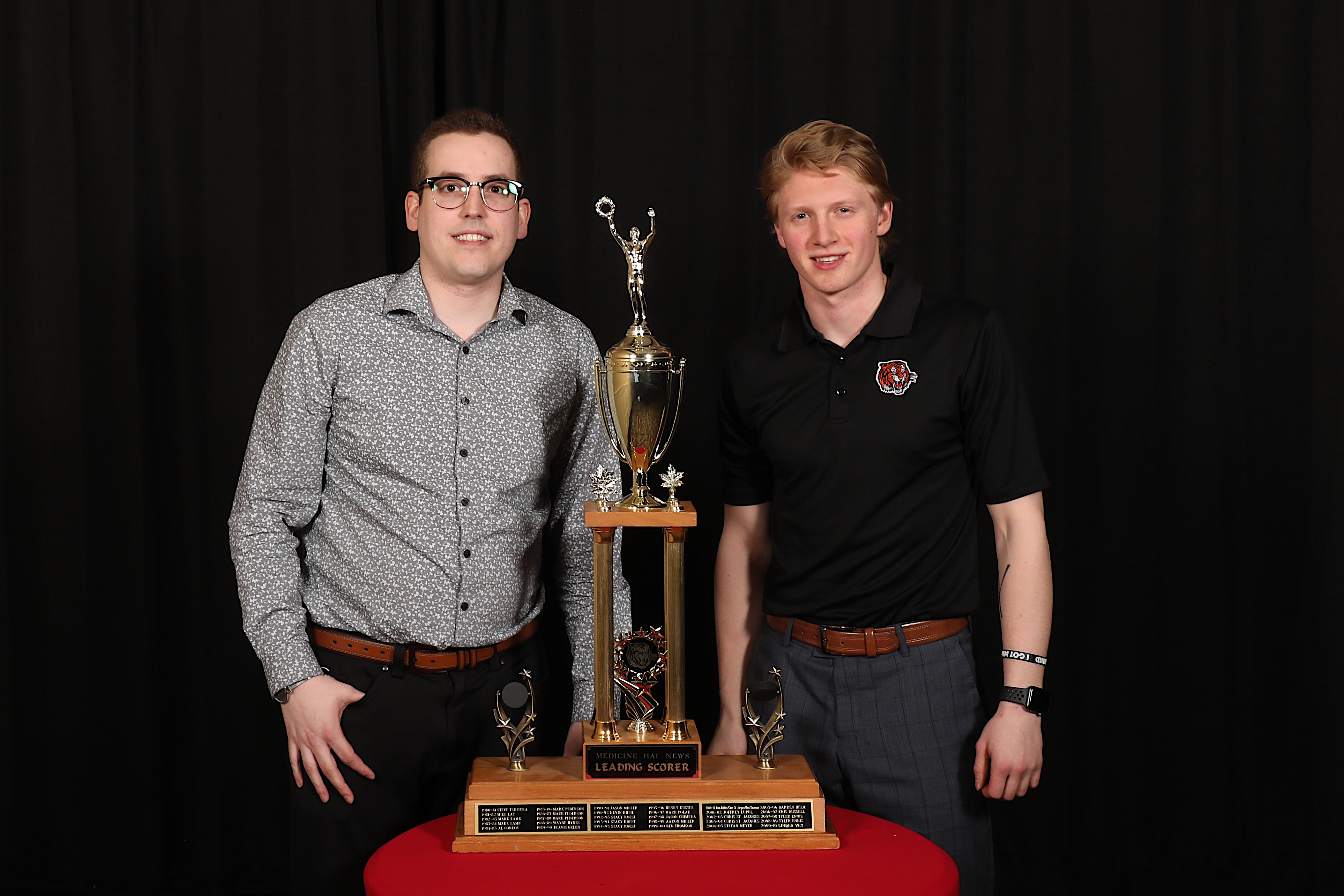 Ryan McCracken of the Medicine Hat News presents the Medicine Hat News Leading Scorer Award to James Hamblin
