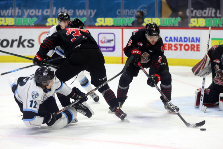 Moose Jaw Warriors defenceman Lucas Brenton moves the puck away from the front of the net during a meeting with the Winnipeg Ice in the Subway WHL Hub. (Keith Hershmiller Photography)