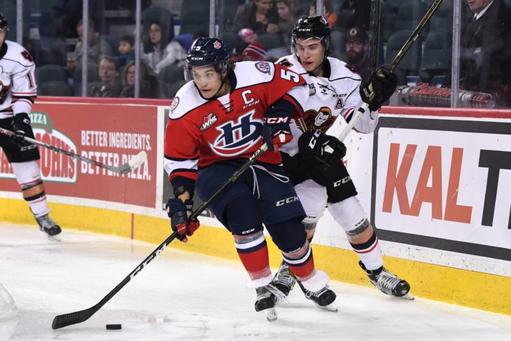 Wong holding off a Hitmen defenceman in the 2016-17 season.